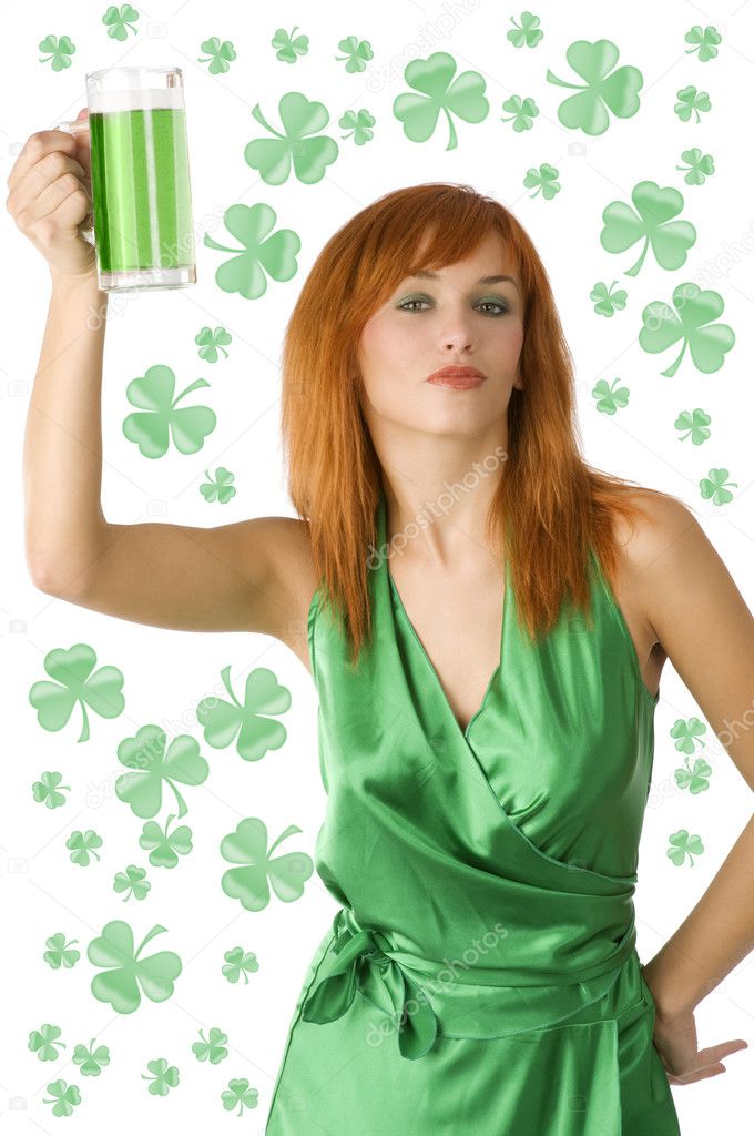 cute redhead girl posing in green dress with a glass of green beer