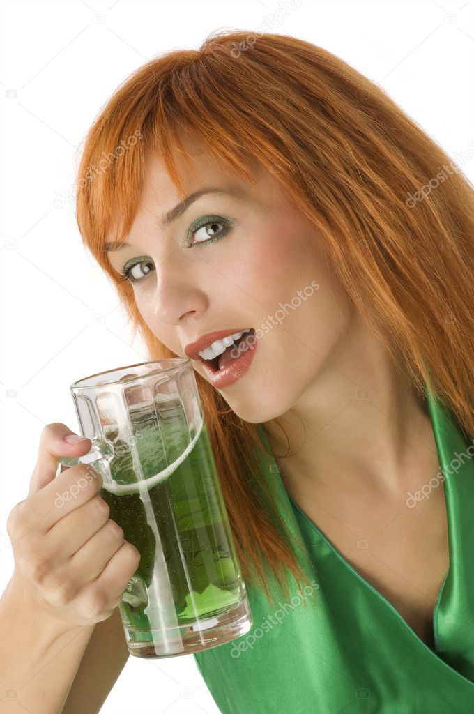 close up of young pretty woman with a glass of green beer