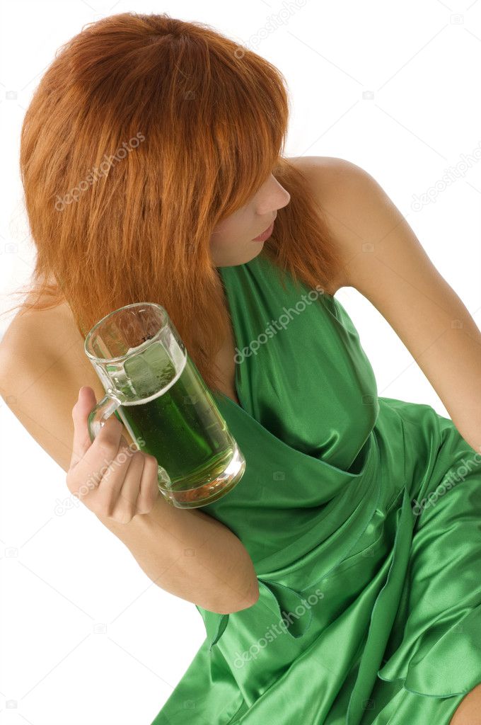 girl with red hair keeping a green beer wearing a green dress