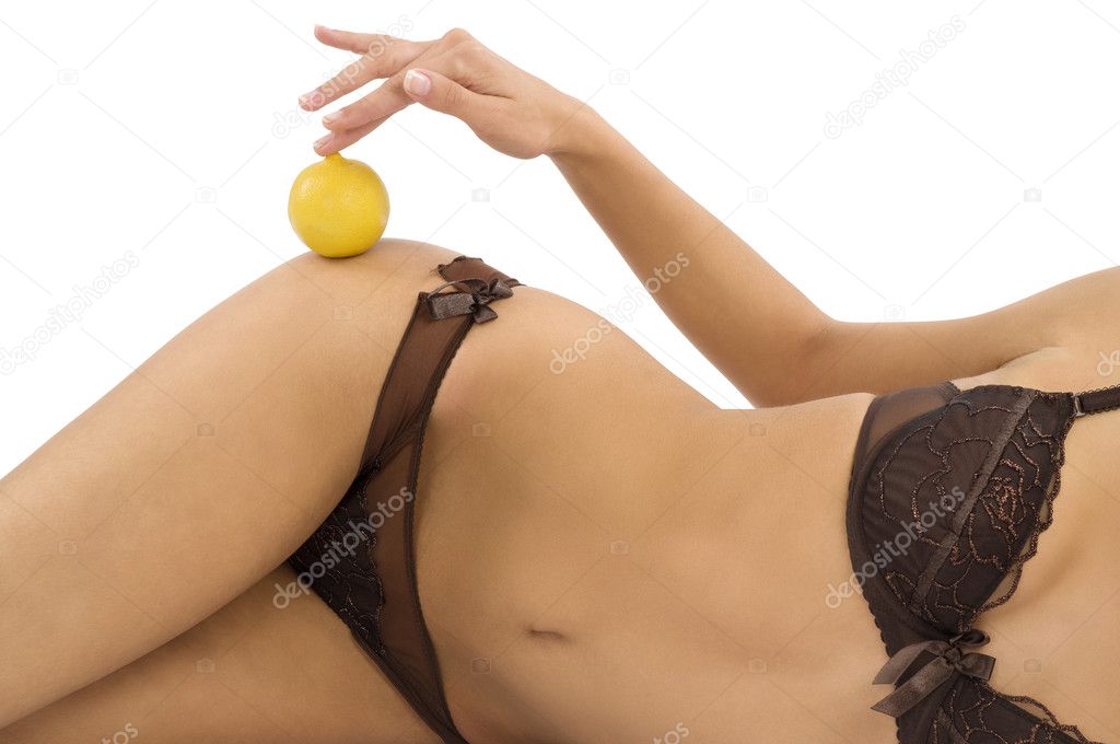 close up of woman in lingerie with a lemon on her body