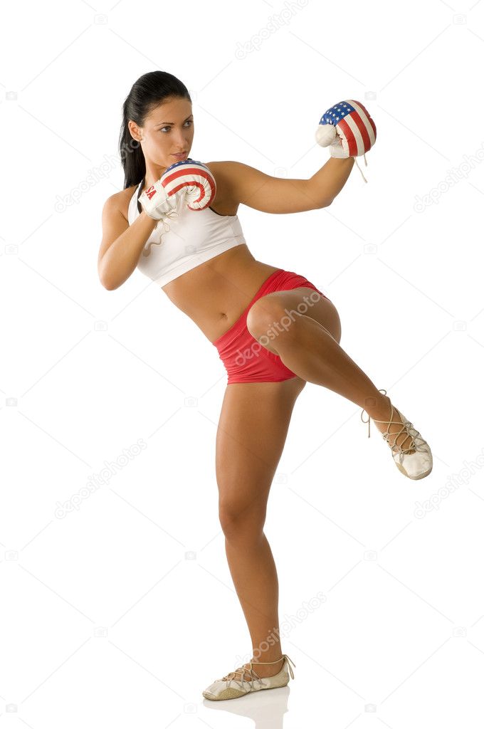 cute brunette with boxing gloves starting to kick
