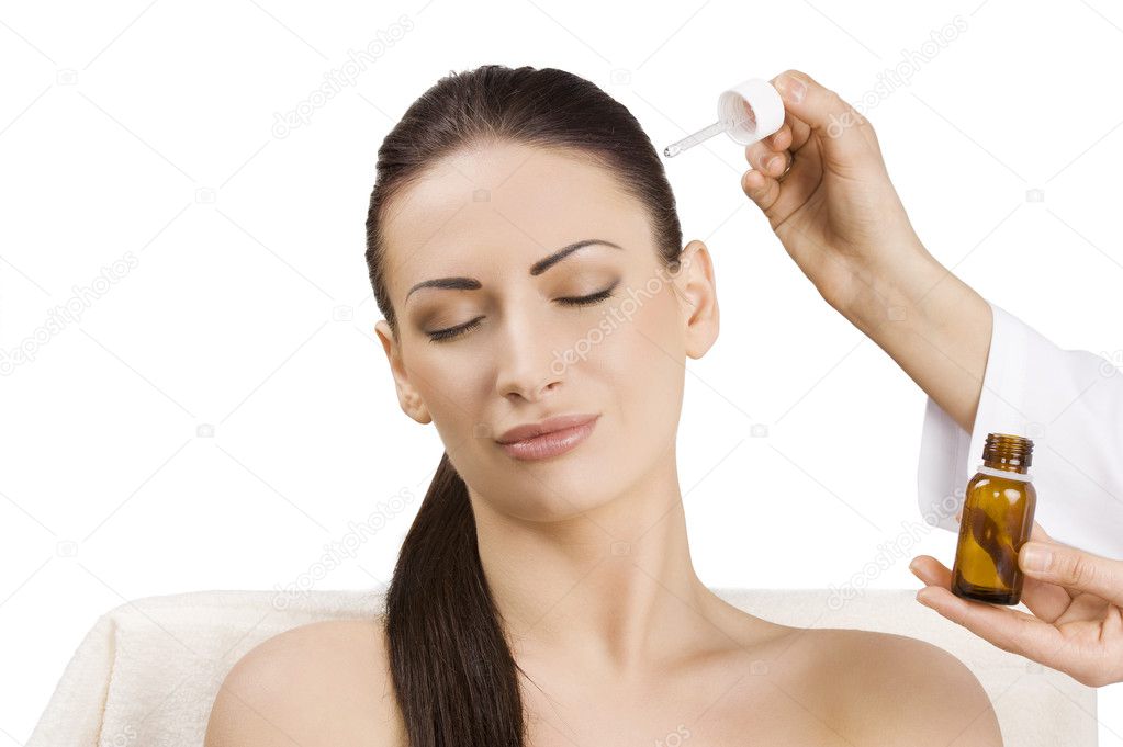beauty advertising portrait of brunette getting a treatment for hair