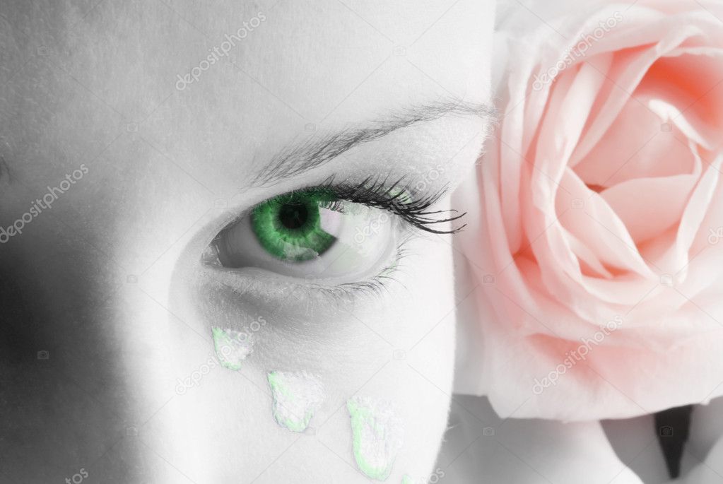 beautiful close up of a green eye and a pink rose and petals painted as tears