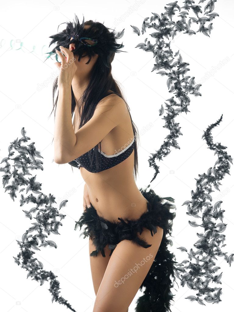 young cute brunette in lingerie with a black carnival mask