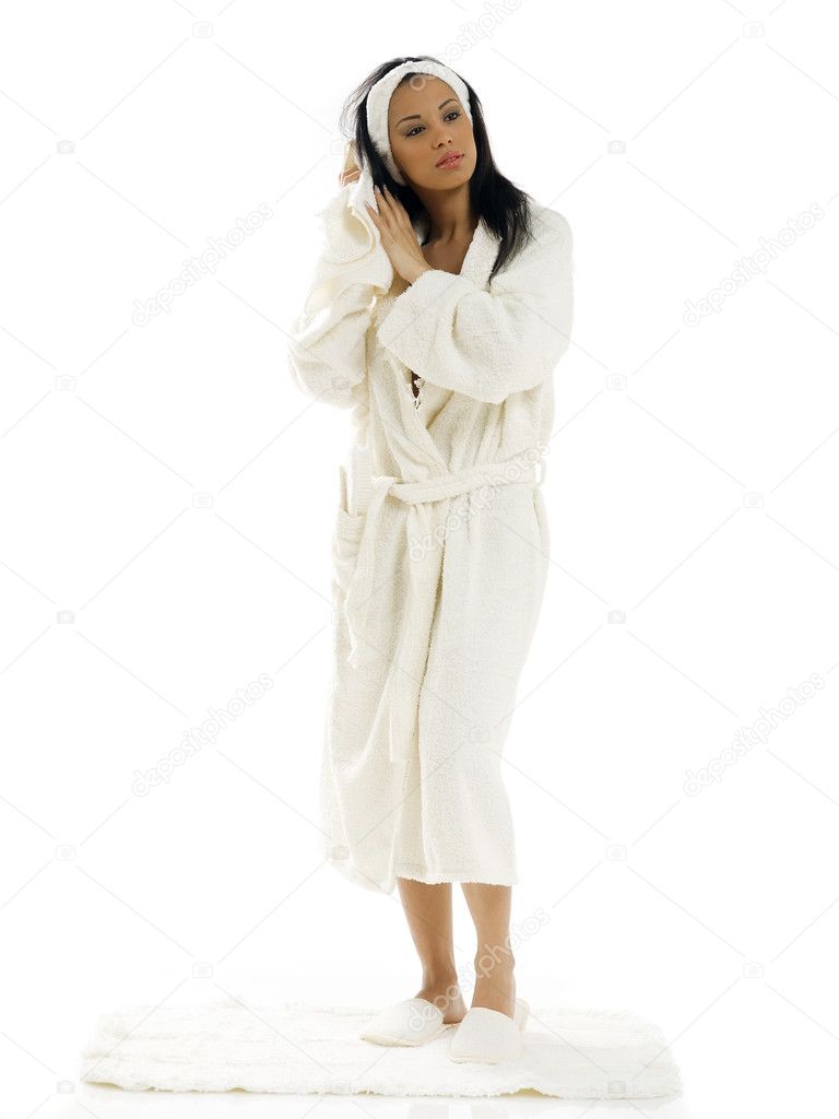 cute and young girl in white bathrobe drying her black hair
