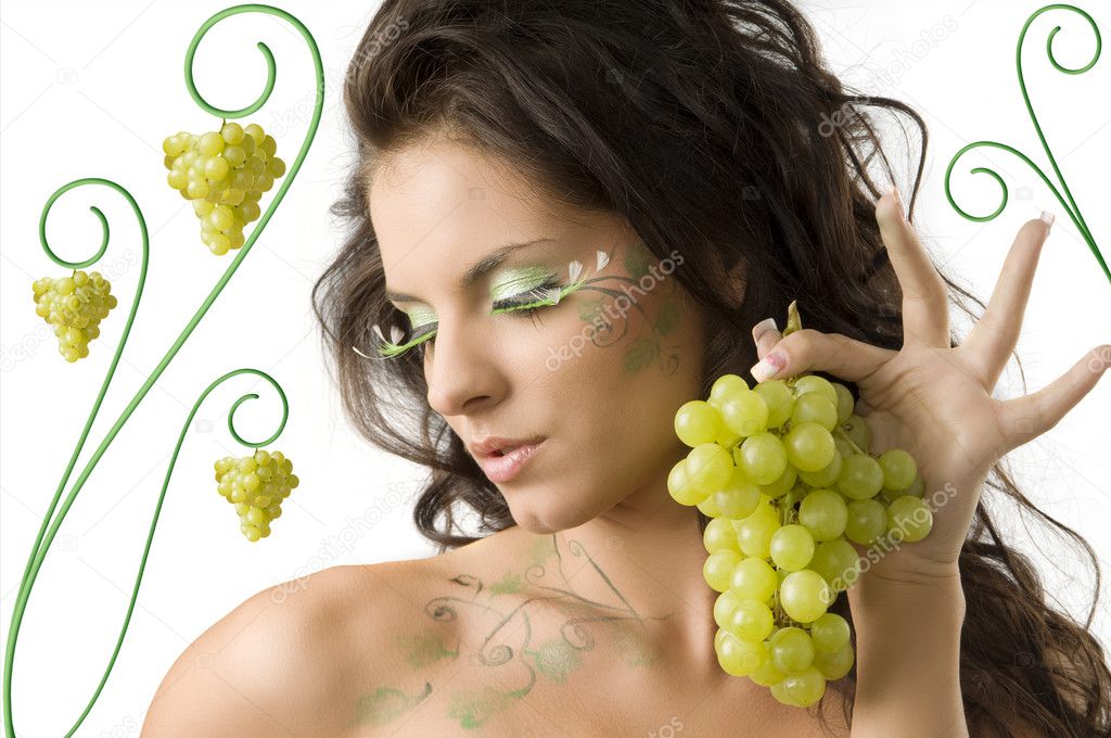 pretty girl with bodypaint on shoulder and face looking down with grape