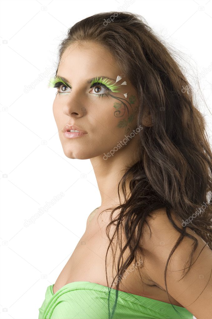 pretty girl with artificial green eyelashes and leaf painted on her face
