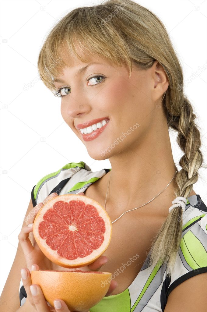 blond and cute girl with green dress showing grapefruit