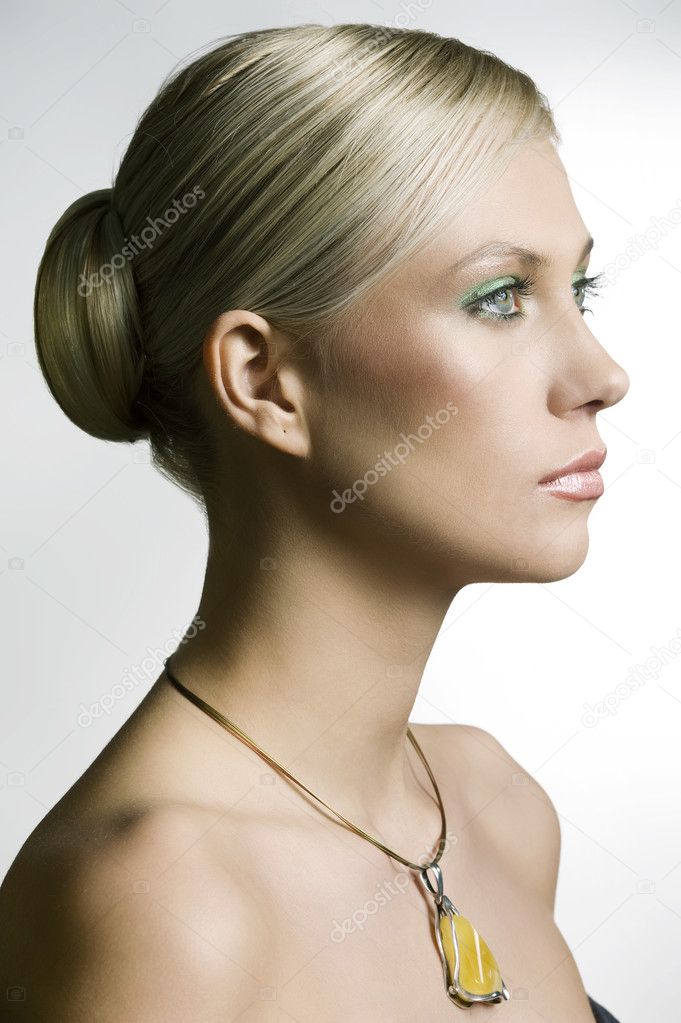 profile portrait of a young and cute woman with hair stylish and a yellow nacklace