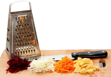 Grated fresh fruits, grater and a knife clipart