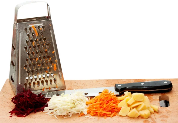 Grated fresh fruits, grater and a knife — Stock Photo, Image