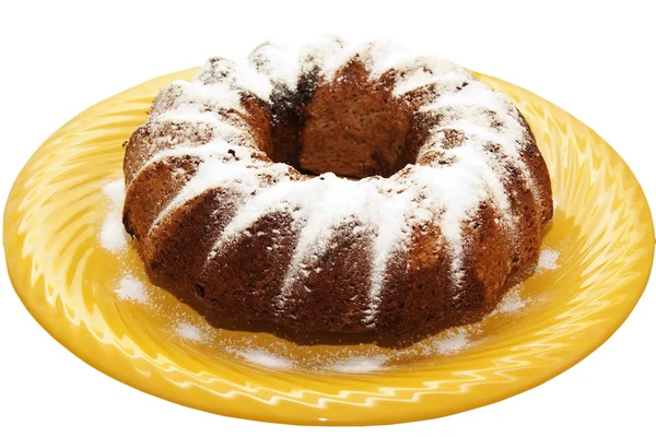 stock image Pie dusted with icing sugar on a yellow plate isolated