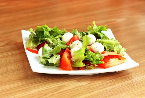 Salad with mozzarella and tomatoes — Stock Photo, Image