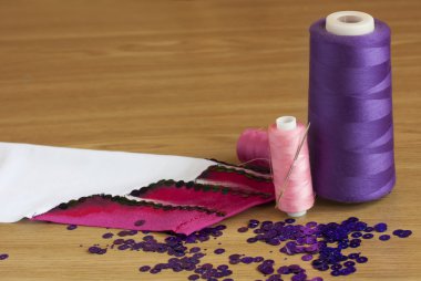 Spools thread and fabric with embroidery clipart