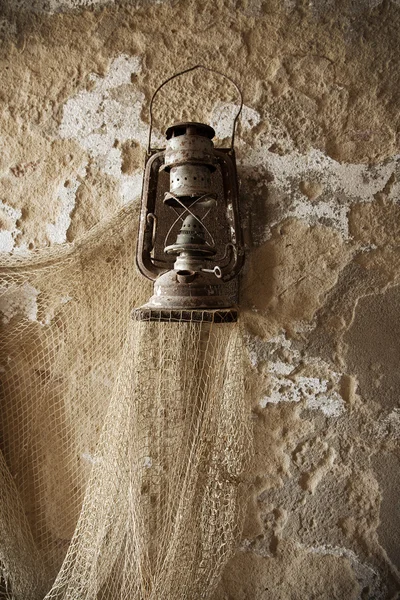 Linterna antigua con tela de pescador Imagen de archivo