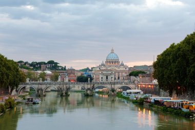 Evening view at the Angelo bridge and St. Peter's Basilica in Rome, Italy clipart