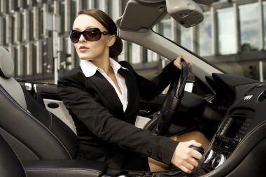 Businesswoman driving a car clipart