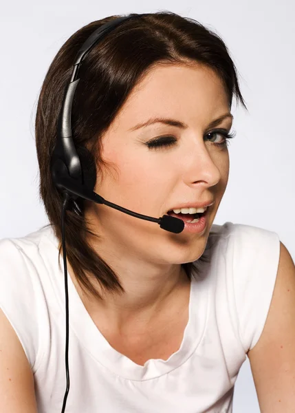 Beautiful girl with dark hair with headphones and microphone wearing white — Stock Photo, Image