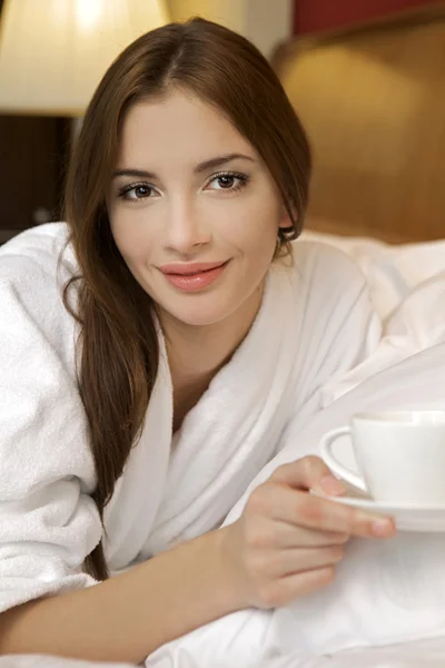 Närbild porträtt av en lycklig ung vacker kvinna med en vit c — Stockfoto