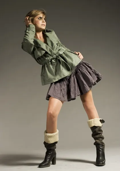 Beautiful Blonde Girl Wearing Green Coat Mini Skirt Grey Background Stock Picture