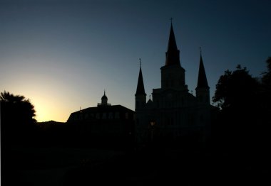 Sun setting behind the St Louis Cathedral in New Orleans clipart