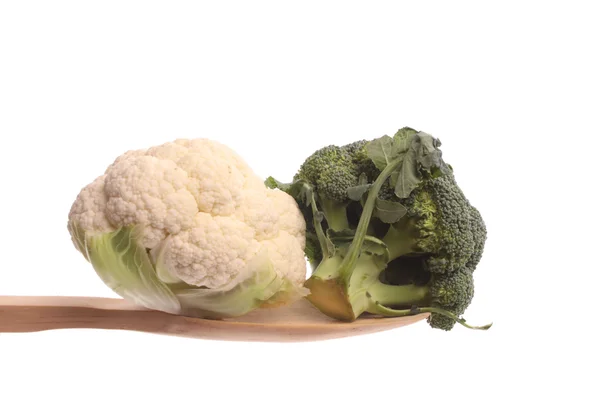 Broccol and a mini cauliflower on a wooden spoon — Stock Photo, Image