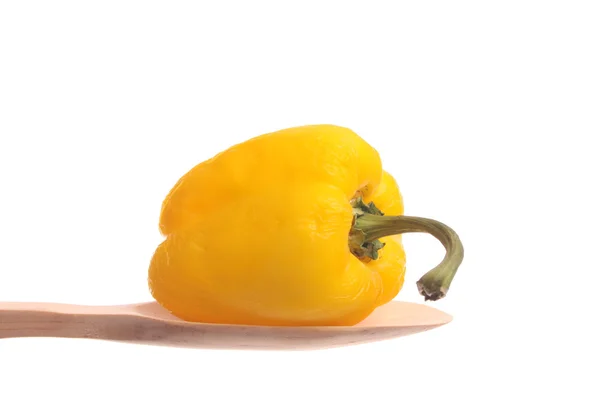 Old bell pepper on a wooden spoon — Stock Photo, Image