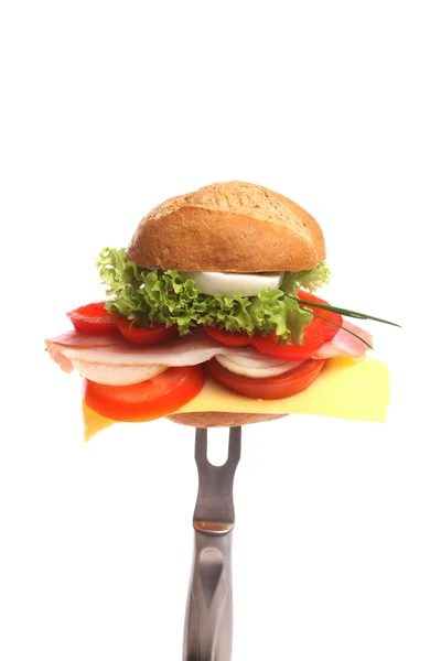 Bread roll for breakfast on a fork — Stock Photo, Image