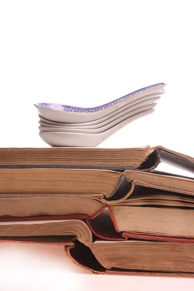 Chinese spoons on a pile of old prescription-books — Stock Photo, Image