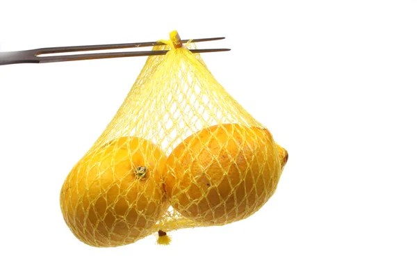 Lemon on a fork in a net — Stock Photo, Image