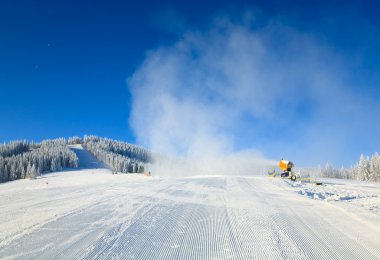 Snowmaking on a mountain ski resort clipart