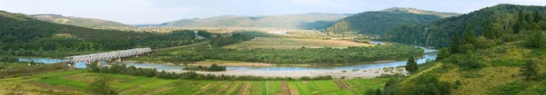 stock image Summer morning foothills panorama with railroad and river