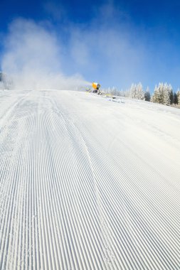 Snowmaking on a mountain ski resort clipart