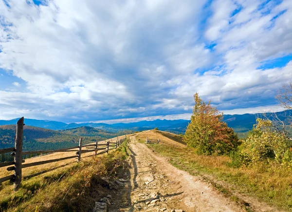 Autumn mountain and country road — Stockfoto