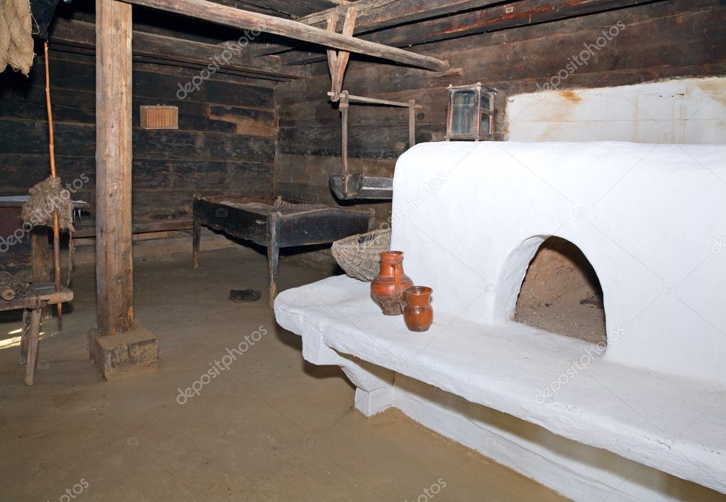 Historical peasant dwelling interior with stove
