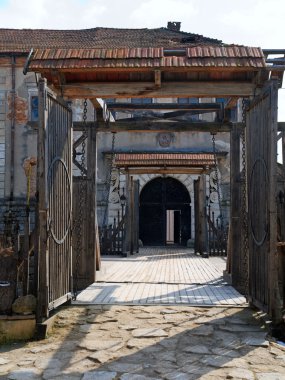 View of bridge gate over the moat to old Zolochiv castle (Ukraine, Lviv Region, Dutch style, built in 1634-36 by Jakub Sobieski) clipart