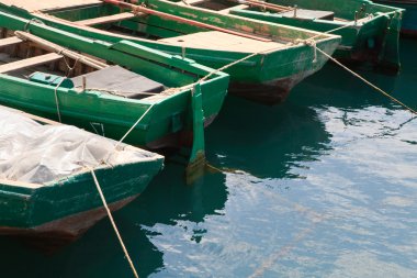 Wooden boats at pier clipart