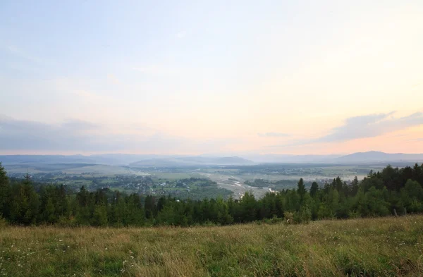 夏の田舎をふもとの小丘の背後にある山と川の渓谷 日没風景します — ストック写真
