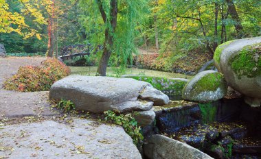 Small waterfall in autumn park clipart