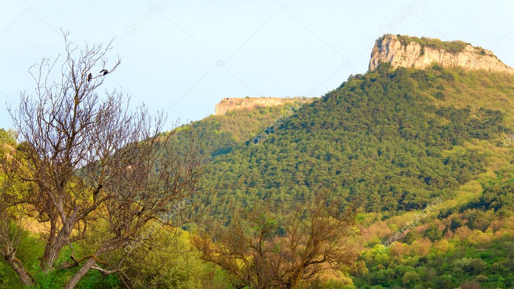 Spring Crimean mountain landscape with Mangup Kale - historic fortress and ancient cave settlement in Crimea, Ukraine.