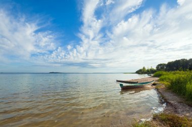 Boat near the summer lake shore clipart