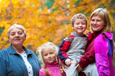 Happy family autumn outdoor portrait clipart