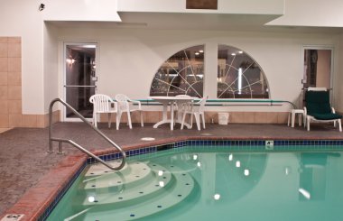 Some hotels in north america offer swimming pools to their guests, a great place to relax clipart