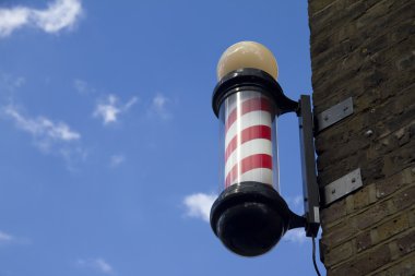 Barber's pole and sky (room for text) clipart
