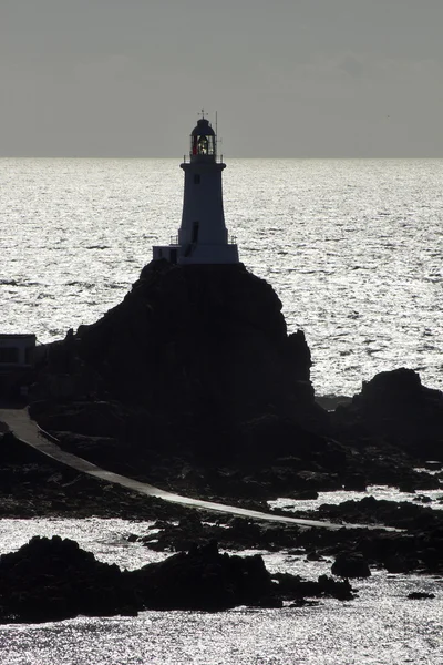 Corbiere lighthouse in silhouette, Jersey — Stock Photo, Image