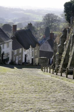 Steep hill and sky in English town clipart