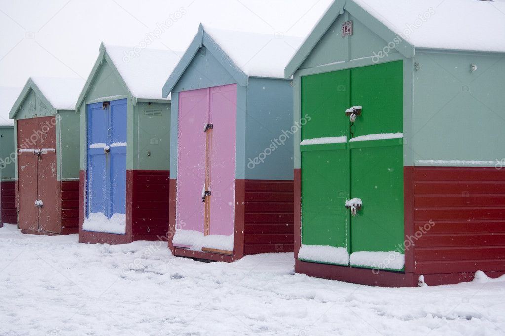 Beach huts in snowy scene