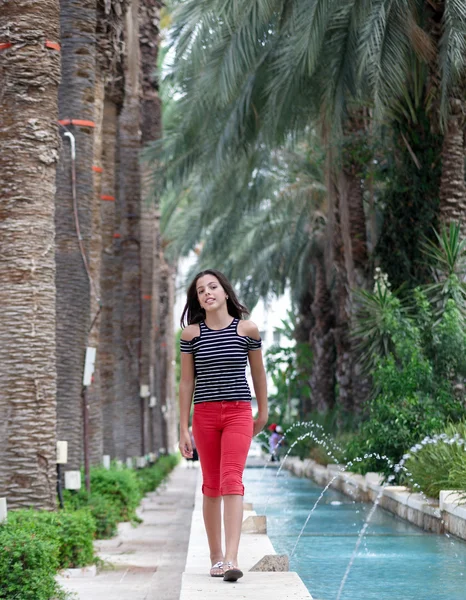 stock image Portrait of a girl near the fountain.