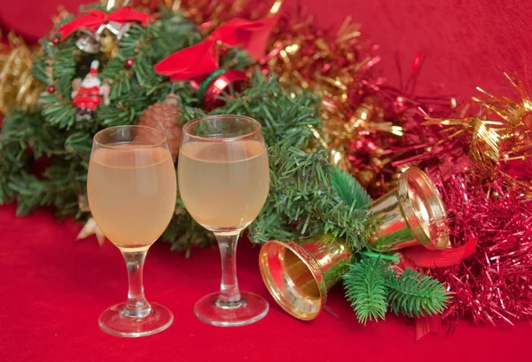 stock image Artificial christmas tree decorated and wine on red background .