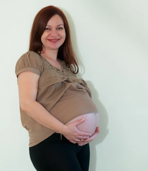 Stock image Happy pregnant woman touching her belly .